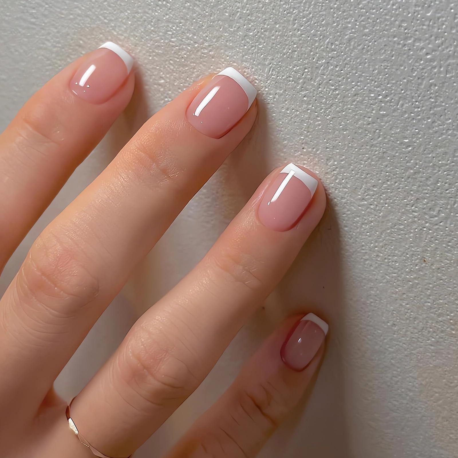 Close-up of elegant French manicure done at Dazzle Studio